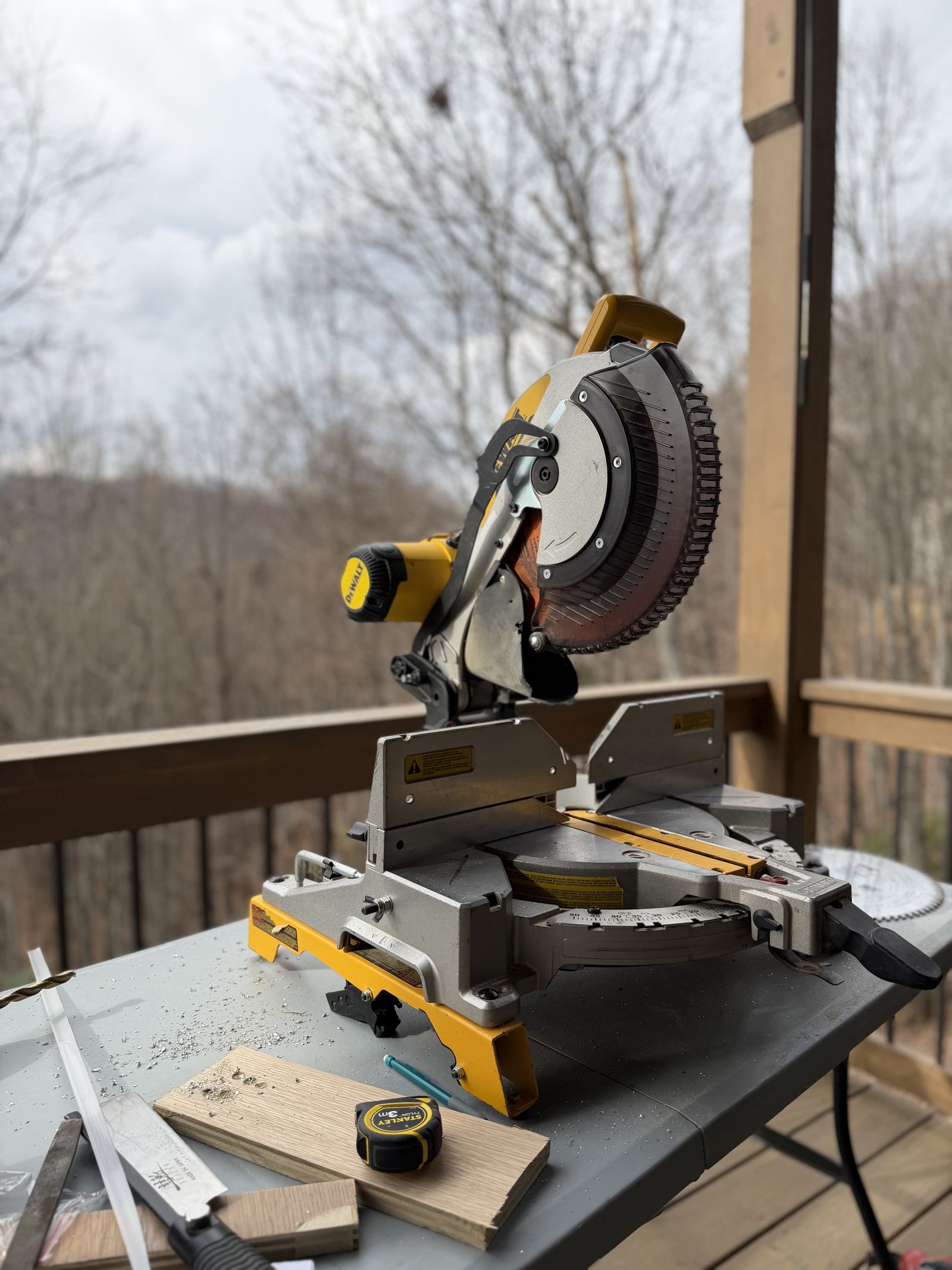 Blue Ridge Carpenters craftsman cutting trim on a miter saw during installation