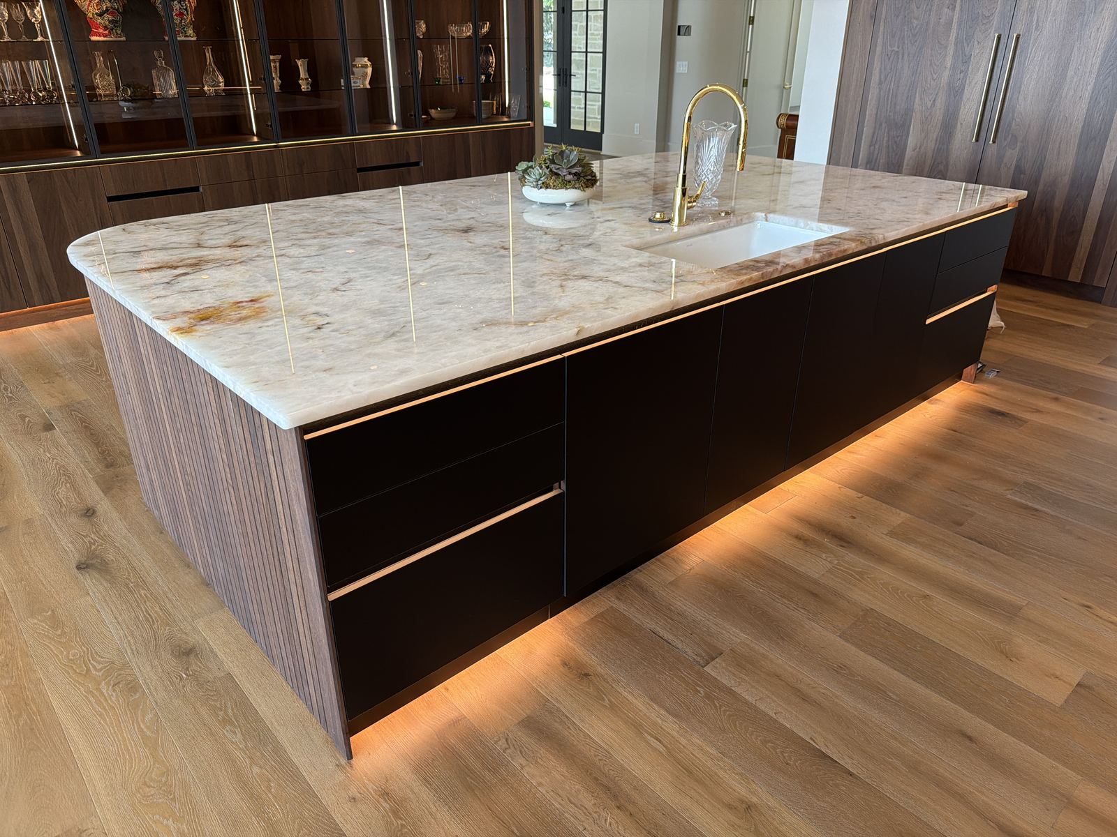 Custom kitchen island with quartzite countertop and painted cabinetry