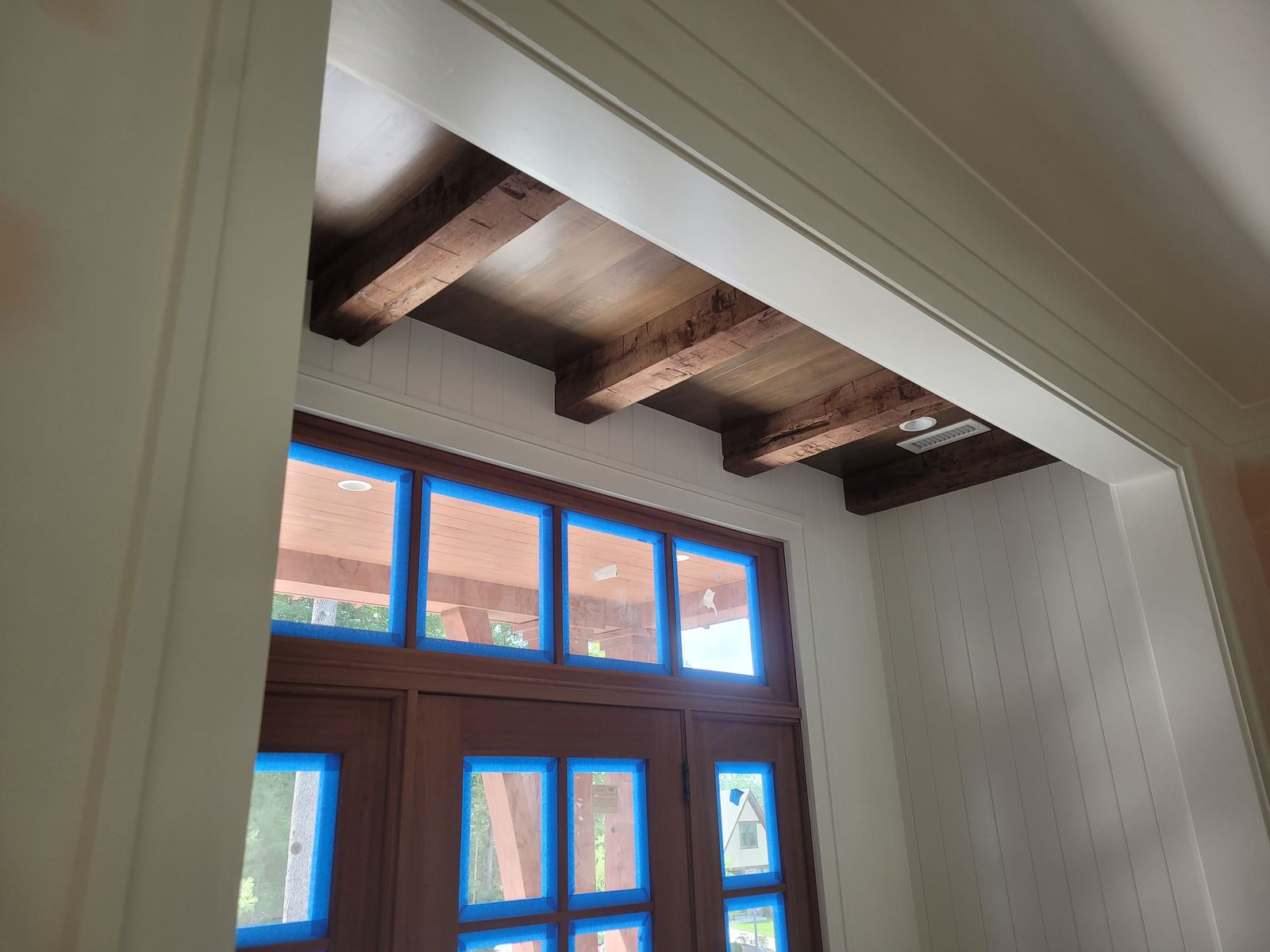 Exposed ceiling beams meeting a full-height window wall