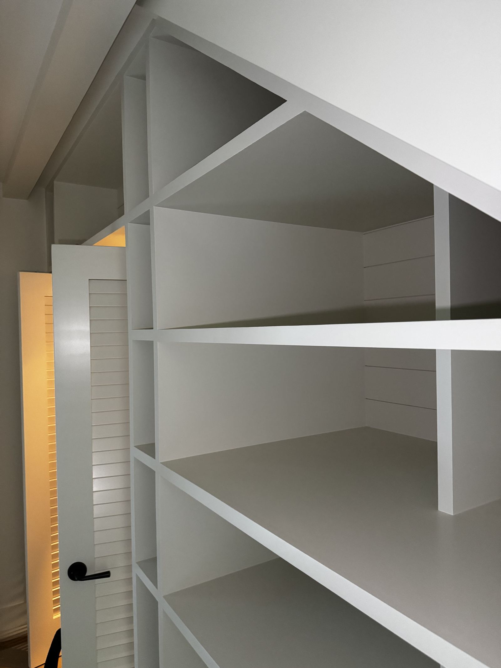 Custom white built-in shelving in a finished room