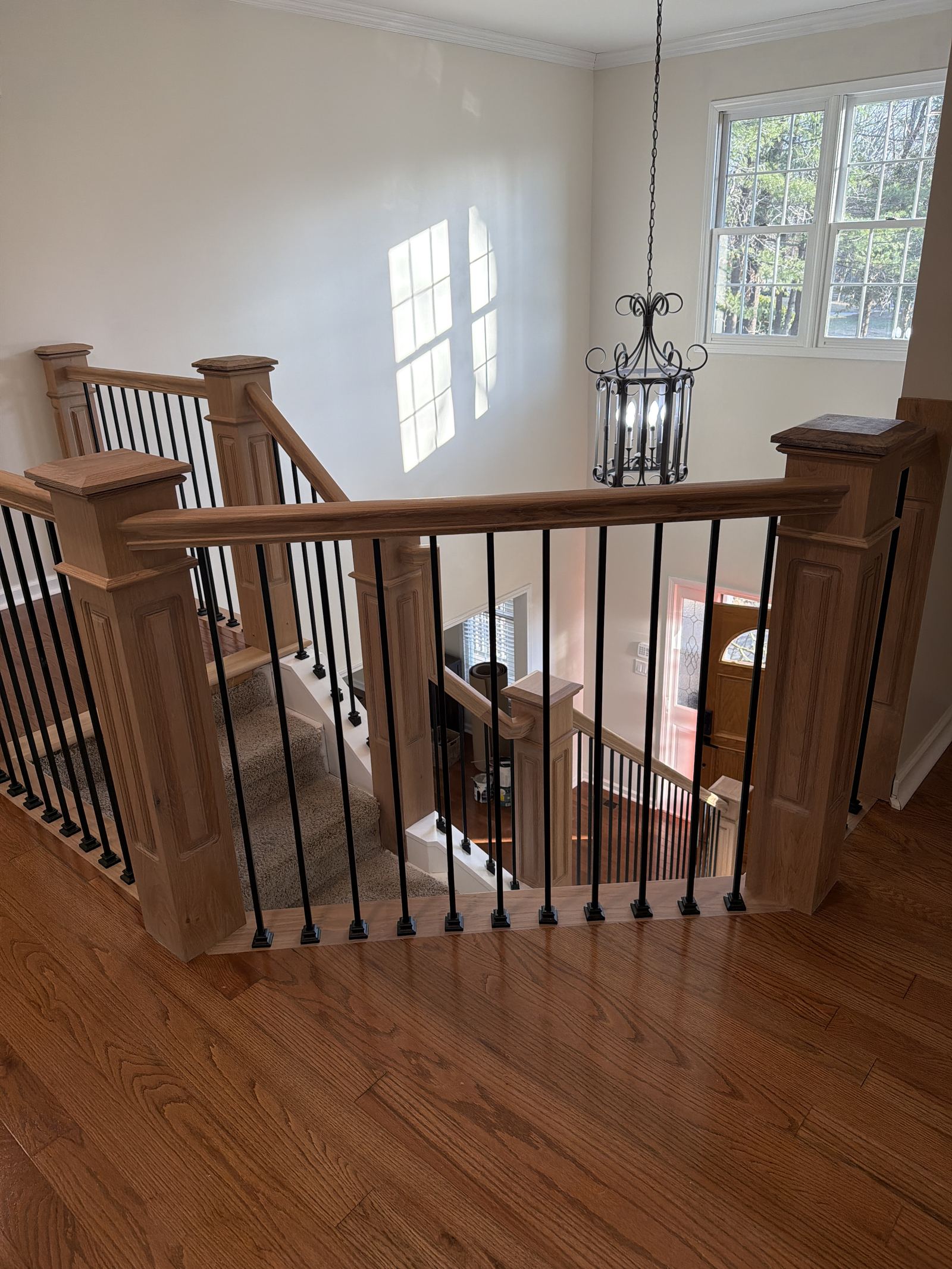 Oak staircase landing with iron railing detail