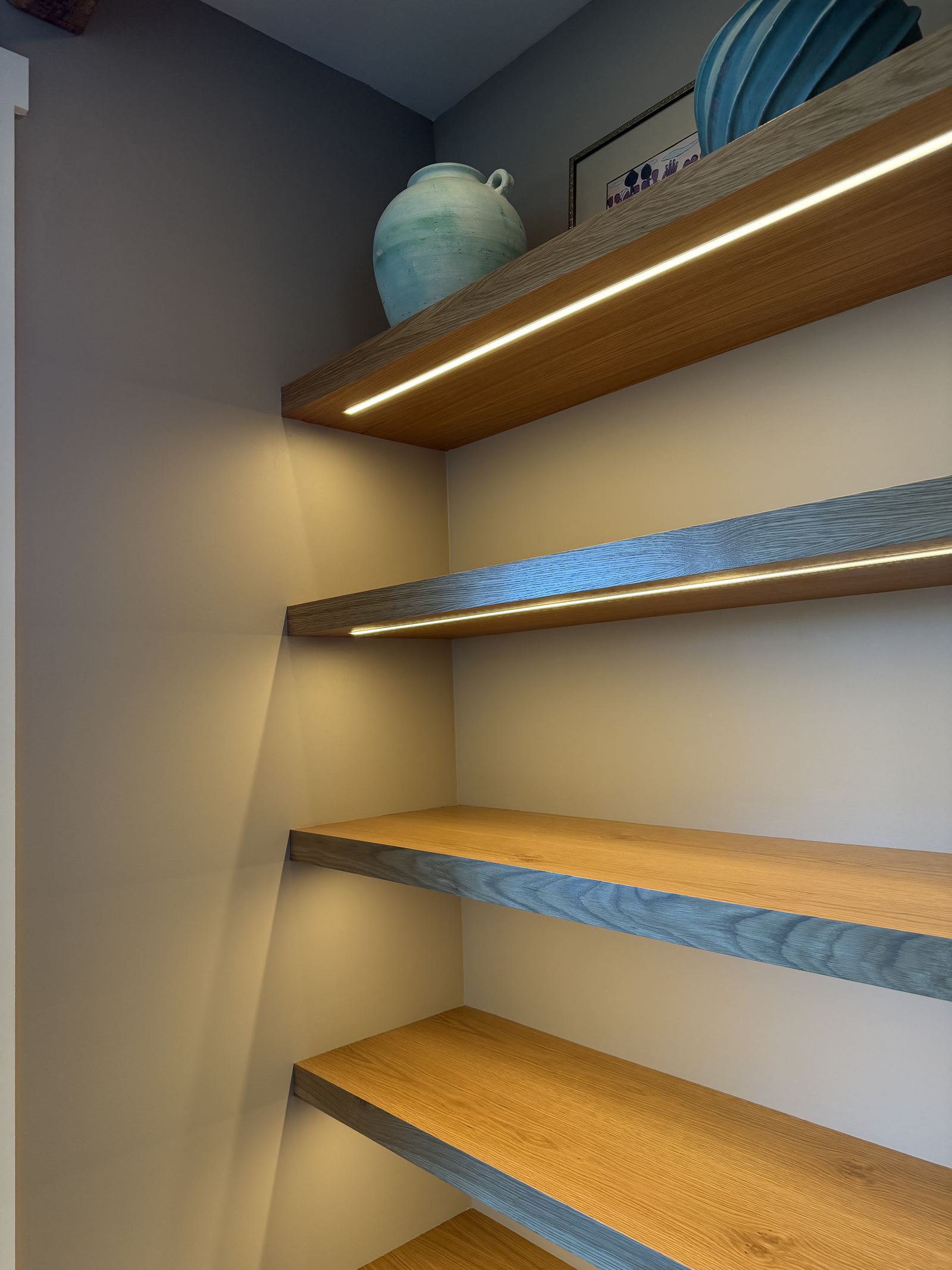Detail of custom built-in shelving with integrated lighting