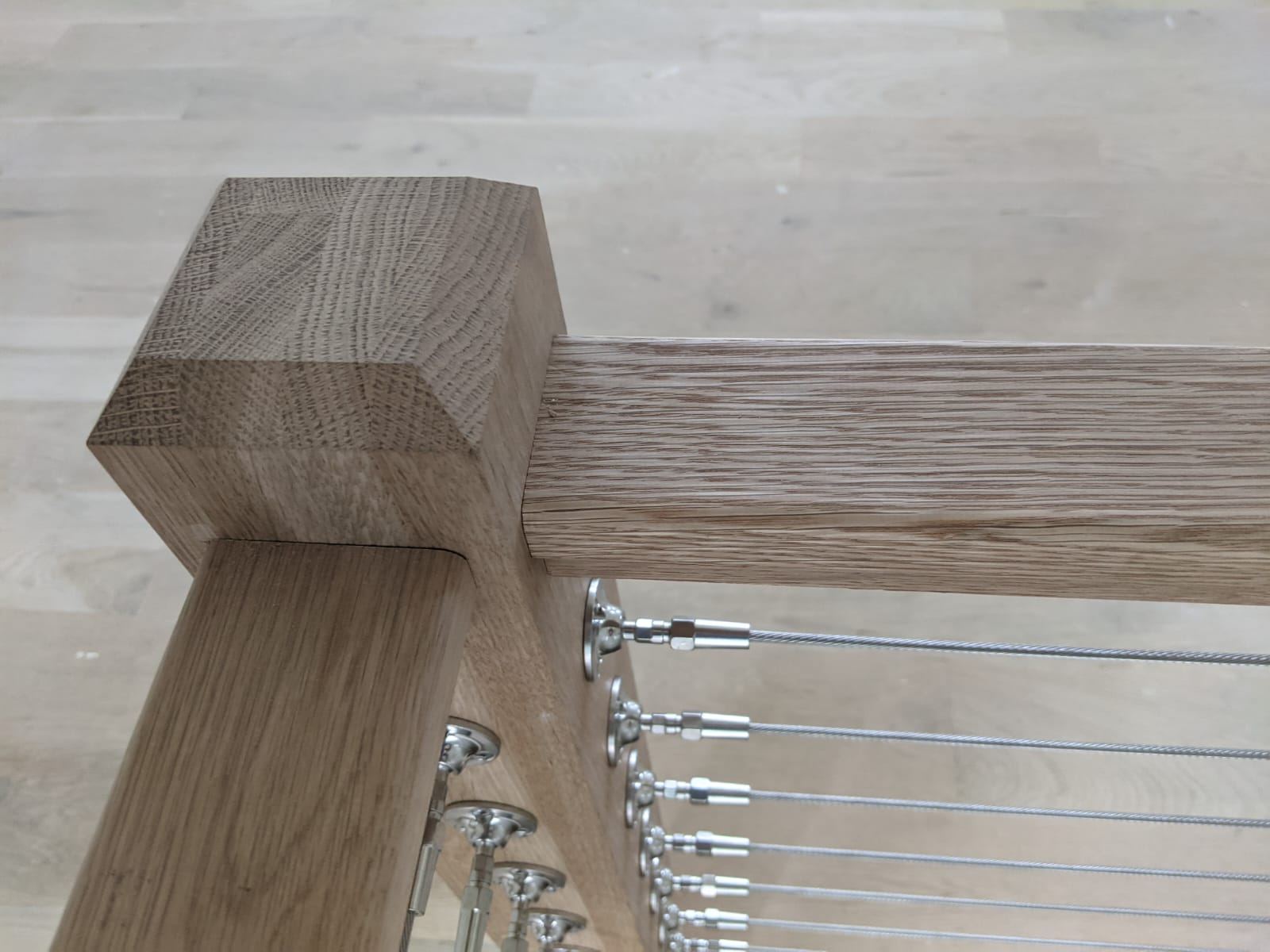 Joinery detail where a white oak stair stringer meets the newel post