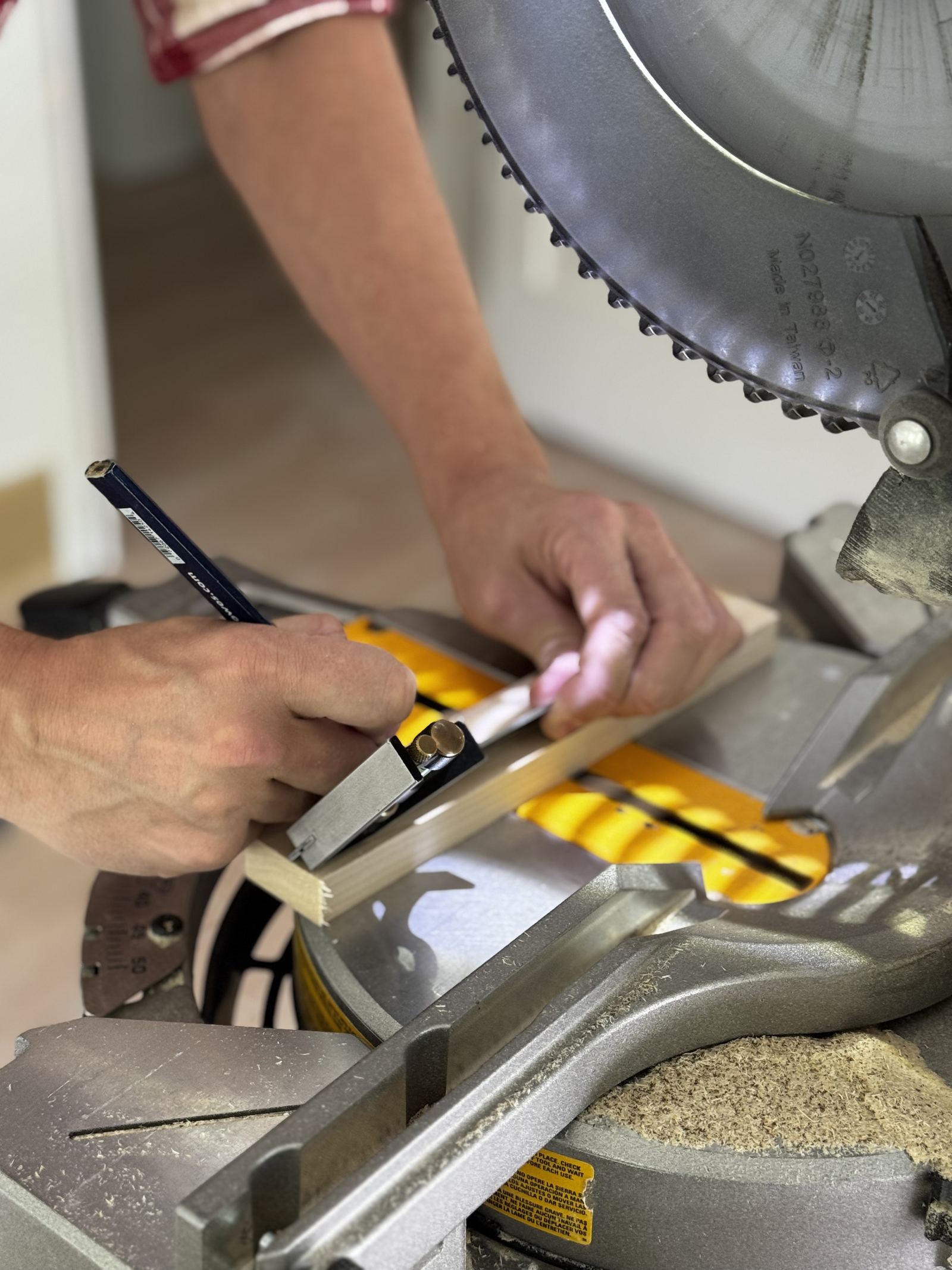 Carpenter hand-cutting a joint on site