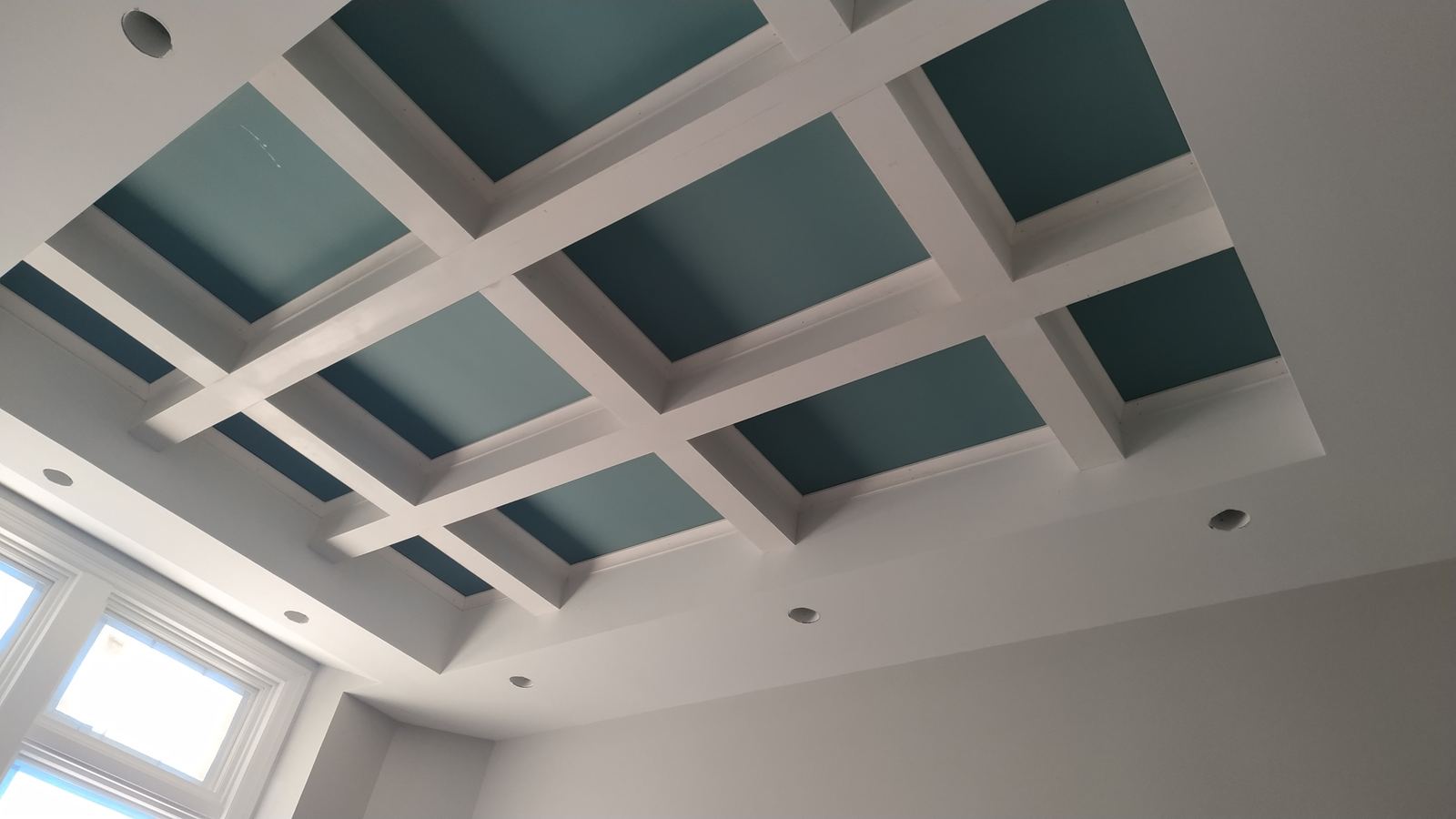 Coffered ceiling with skylight opening and painted panels