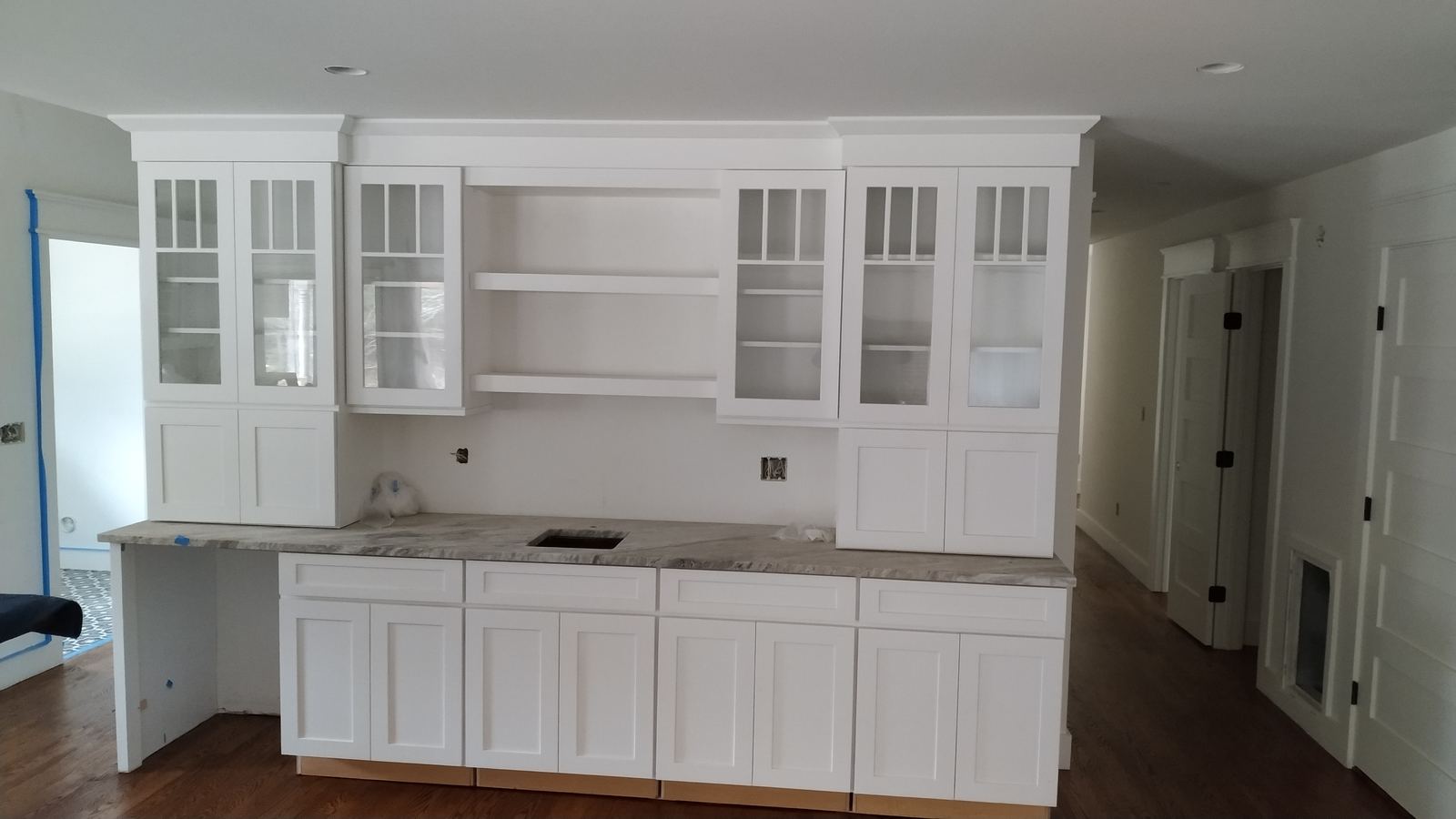 Custom white built-in hutch with fitted shelving and cabinetry
