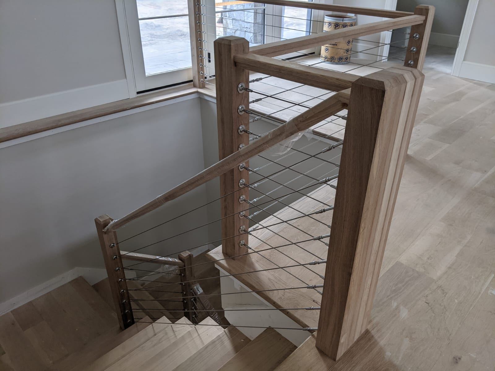 White oak newel post and cable railing termination detail